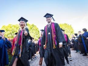 Class officers Diego Sanjuan and Bethany Perry lead the line of 2024 graduates